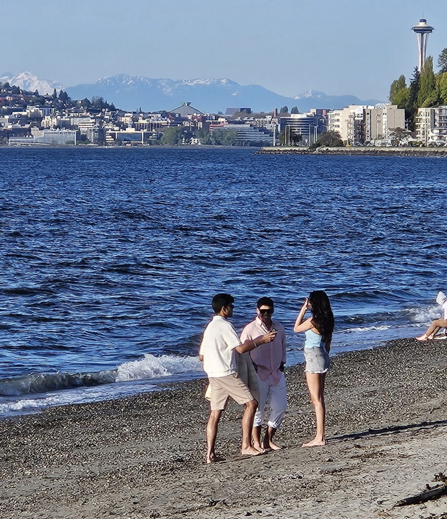 Space Needle is visible from the open water swimming area at Alki Beach