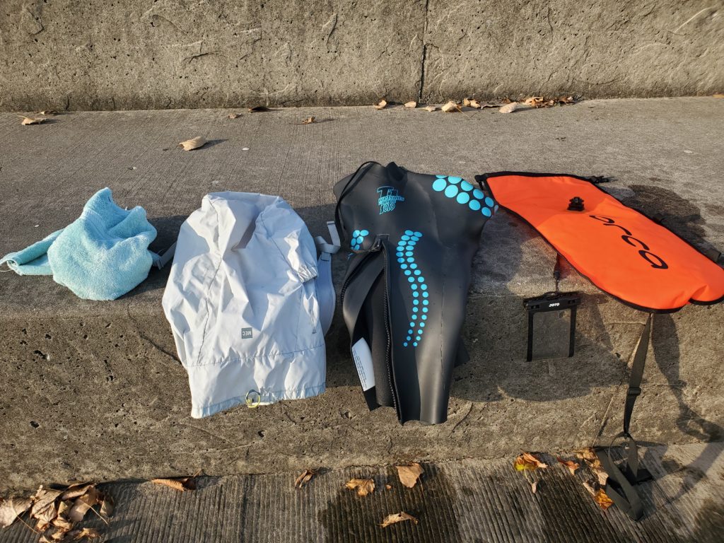 Everything needed in the water for the swim fit neatly in a backpack. All dry land gear, including shoes, fit in the open water swim buoy (tow float) while swimming.
