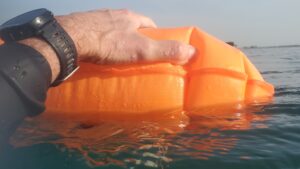 Taking a rest during a hard open water swim with an open water swim buoy / tow float.
