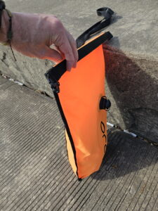 First fold of the open water swim buoy dry bag closure 