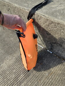 Third fold of the open water swim buoy dry bag closure 