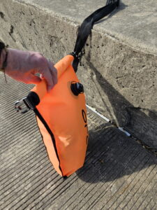Fourth fold of the open water swim buoy dry bag closure ready to close an open water swim buoy 