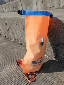 New Wave Swim Buoy Dry bag loaded with Water Shoes, Big Beach Towel and light windbreaker